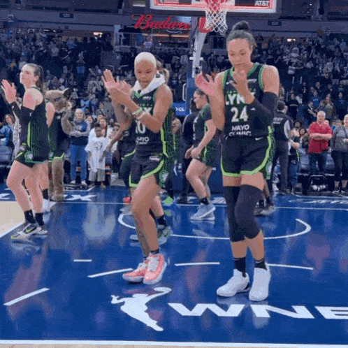 a group of female basketball players are clapping and wearing jerseys that say mayo