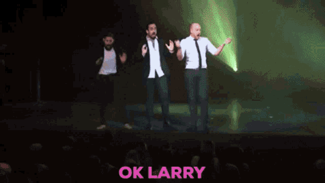 a man in a white shirt and tie is dancing in front of a green light with the words listen here written in pink .