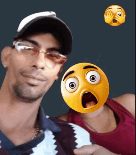 a man and a woman are posing for a picture with a surprised smiley face on the man 's face