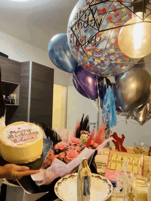 a person holding a cake that says happy birthday