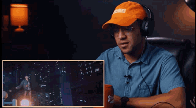 a man wearing headphones and an orange hat that says california