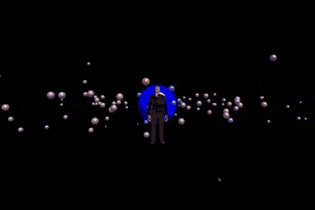 a man in a blue suit is surrounded by spheres and says viyons