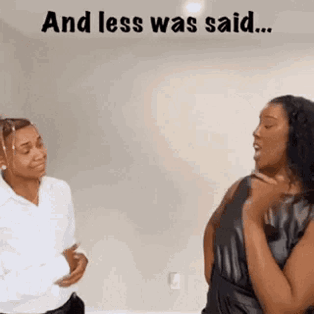 a couple of women are standing next to each other in a room .