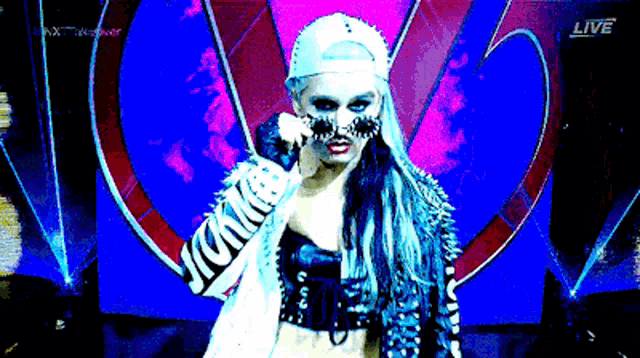 a female wrestler is standing in front of a live broadcast
