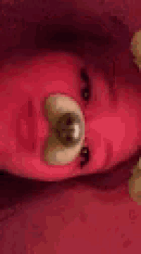 a close up of a person 's face with a teddy bear mask on .