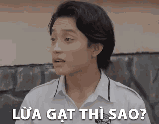a young man in a white shirt with the words lua gat thi sao written above him