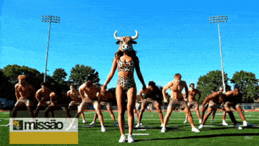 a group of men are dancing on a field with the word missao on the bottom right