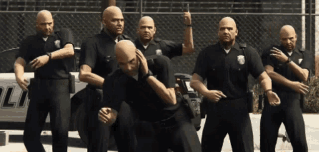 a group of bald police officers stand in front of a police car