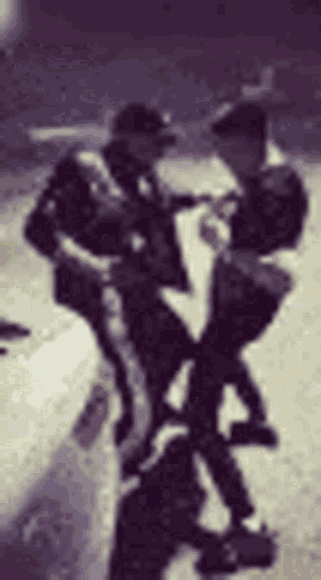 a blurry picture of two men sitting on a bench on the side of the road .
