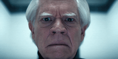 a close up of a man 's face with gray hair