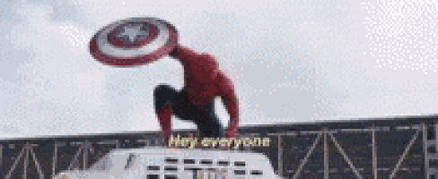 a spider-man is holding a captain america shield in his hand .