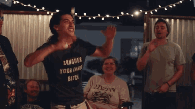 a man wearing a black shirt that says " wasted your inner bitch "