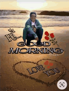 a man is squatting on a beach with a heart drawn in the sand that says " good morning love you "