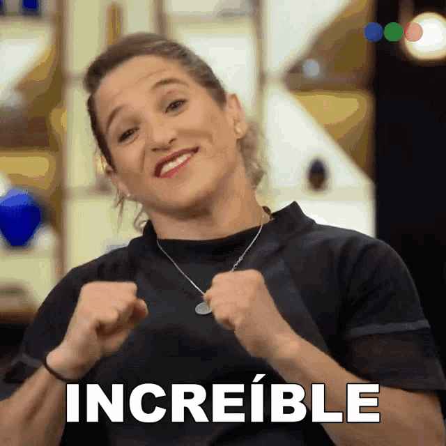 a woman in a black shirt is making a funny face and the word increible is on the bottom