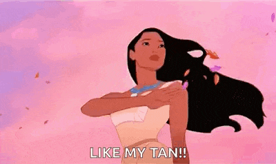 pocahontas from disney princess is standing in the wind with her arms outstretched and saying `` like my tan ! ''