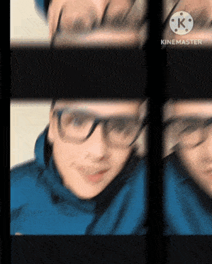 a blurred image of a person wearing glasses and a blue jacket with a k on the bottom right