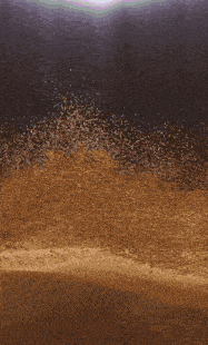 a pile of dirt is being blown in the air