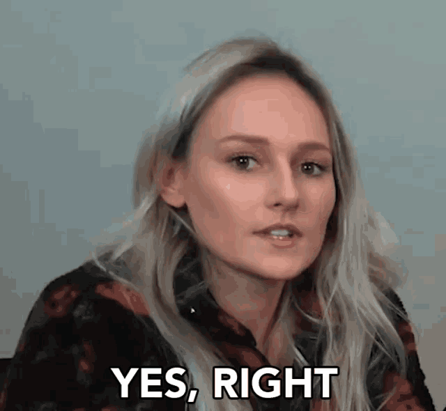 a woman says yes right in front of a wall
