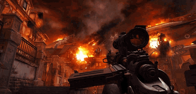 a person is holding a rifle in front of a fire