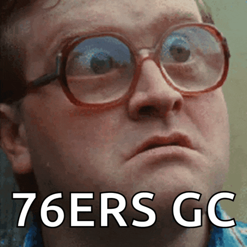 a man wearing glasses says 76ers gc on the bottom of his face