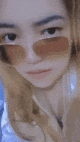 a blurry picture of a woman wearing sunglasses and the words manda 378 written on the bottom