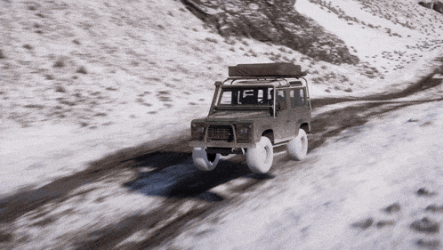 a car with a tent on top of it is driving on a snowy road