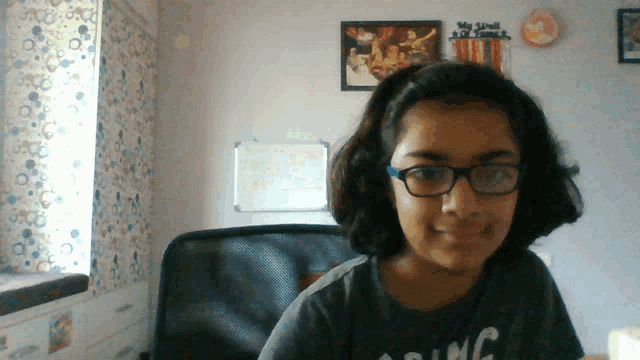 a girl wearing glasses and a t-shirt that says riding