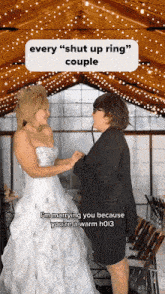 a woman in a wedding dress is holding hands with another woman
