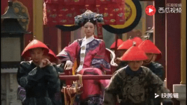 a woman in a red dress is sitting on a throne