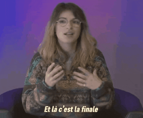 a woman wearing glasses and a sweater says et la c'est la finale .