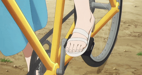 a person wearing white sandals is riding a bicycle