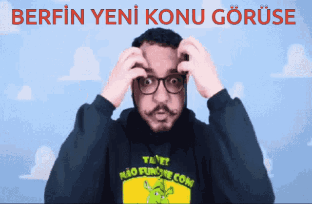 a man wearing glasses and a shirt that says " tane " on it