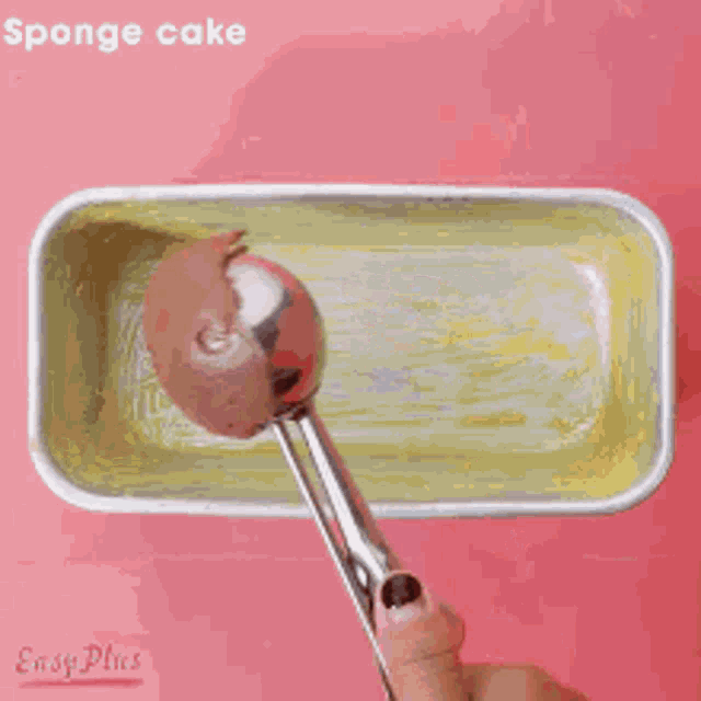 a loaf pan filled with chocolate ice cream is on a pink surface .