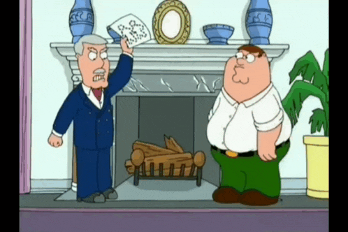 two men are standing in front of a fireplace and one is holding a piece of paper