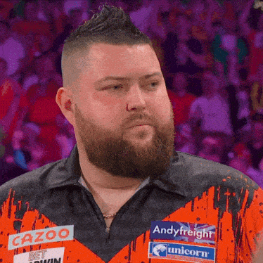 a man with a beard is wearing a shirt that says cazoo bet win