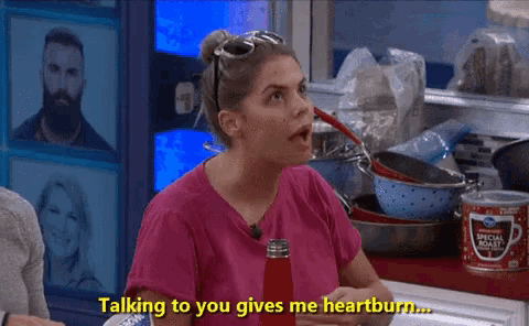 a woman in a pink shirt is talking to someone and says talking to you gives me heartburn ..