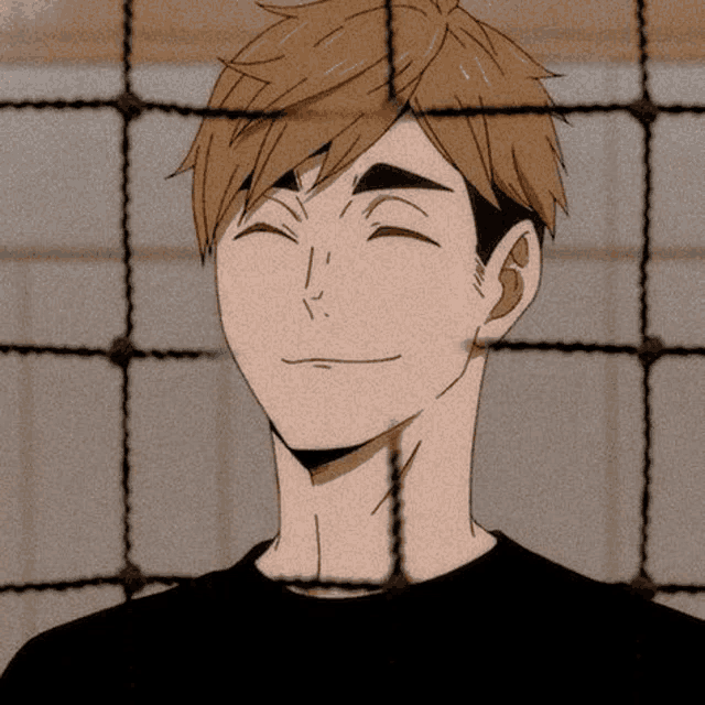 a close up of a man 's face behind a volleyball net .