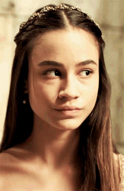 a close up of a woman 's face with a headband on