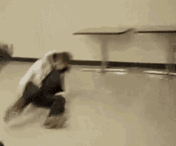 a person is laying on the floor in a room with a table in the background .