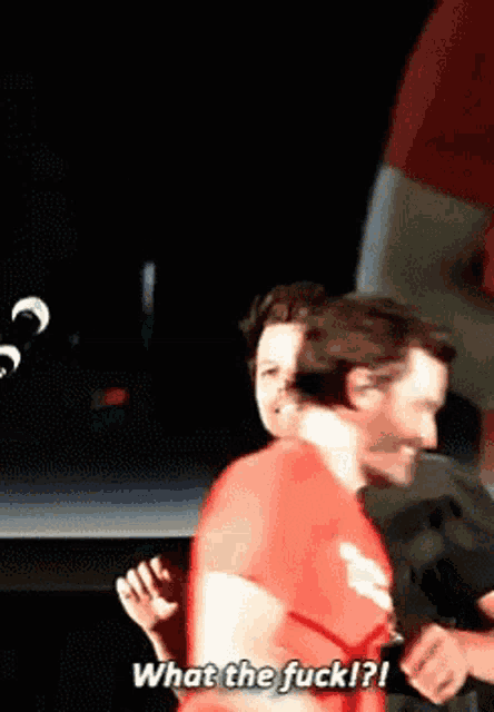 a man in a red shirt says " what the fuck "