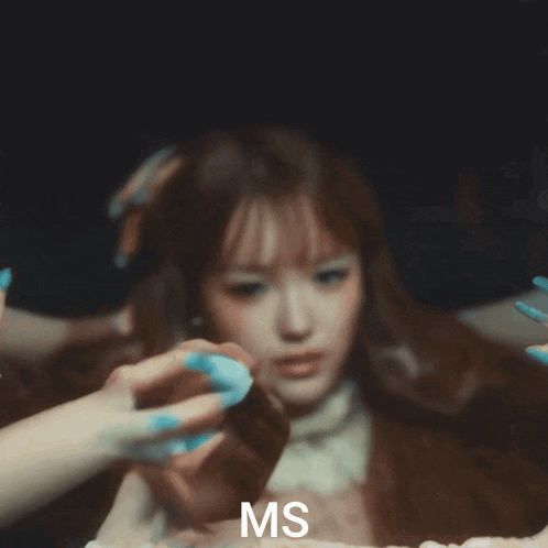 a close up of a woman 's face with the letters ms visible