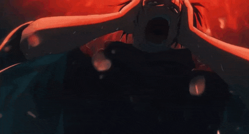 a close up of a person screaming with their mouth open in the dark .