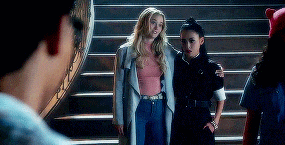 a group of people standing on a set of stairs looking at a man .