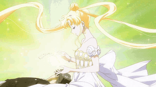 a woman in a white dress is touching a man 's face