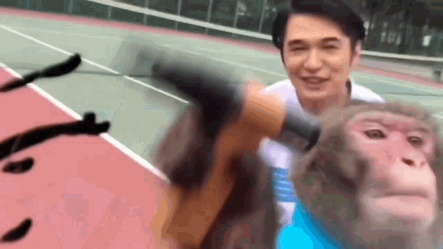a man is holding a tennis racquet and a monkey is sitting on his back .