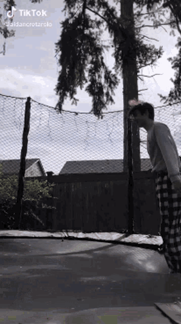 a man is jumping on a trampoline with a tik tok watermark
