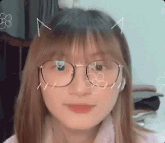 a girl wearing glasses and headphones is looking at the camera and smiling .
