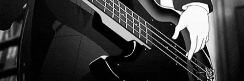 a man is playing a bass guitar in a black and white photo .