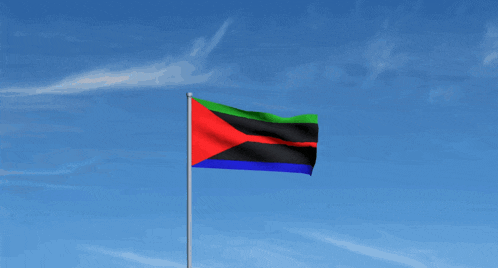 a flag with a red black and green stripe is flying in a blue sky