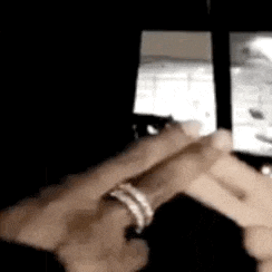 a close up of a person holding a cell phone in their hand .